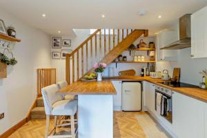 a kitchen with white cabinets and a wooden counter top at 1 Bed in New Mills oc-p29603 in Mellor +16 photos