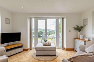 a living room with a flat screen tv and a couch at 1 Bed in New Mills oc-p29603 in Mellor