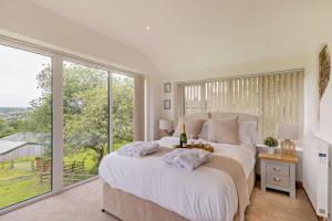 a bedroom with a large bed with a large window at 1 Bed in New Mills oc-p29603 in Mellor