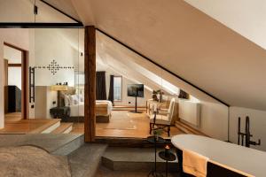 a bathroom with a tub and a bedroom at Castel Badia - The Leading Hotels of the World in San Lorenzo di Sebato