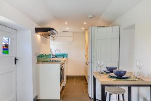 a kitchen with a small table and a sink at 1 Bed in Morwenstow oc-t29298 in Morwenstow