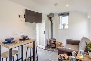 a living room with a couch and a fireplace at 1 Bed in Morwenstow oc-t29298 in Morwenstow
