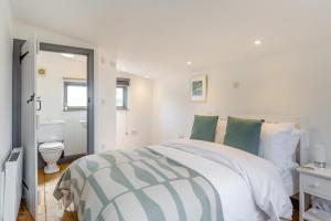a white bedroom with a bed and a toilet at 1 Bed in Morwenstow oc-t29298 in Morwenstow