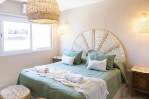 a bedroom with a bed with towels on it at Giova Apart Salta in Salta