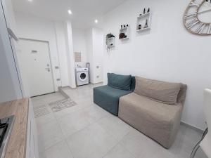 a living room with a couch and a washing machine at B&B Sabò in Bologna