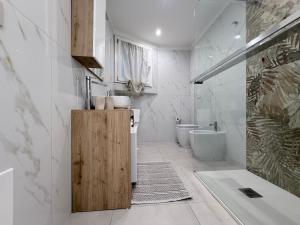 a bathroom with a tub and a toilet and a sink at B&B Sabò in Bologna +71 photos