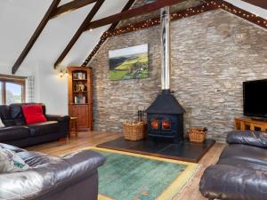 a living room with a stone wall with a fireplace at 4 Bed in Hebron oc-y30097 in Whitland