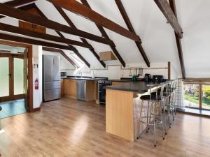 a large kitchen with wooden floors and wooden beams at 4 Bed in Hebron oc-y30097 in Whitland