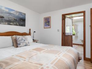 a bedroom with a large bed and a doorway at 4 Bed in Hebron oc-y30097 in Whitland +16 photos