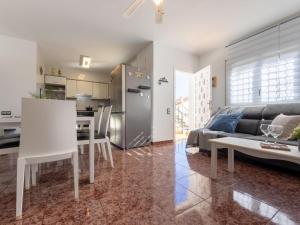 a kitchen and living room with a couch and a table at Holiday Home Estrella by Interhome in Riumar