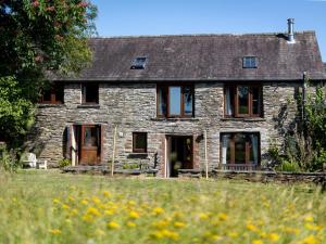 an old stone house with a field of flowers at 4 Bed in Hebron oc-y30097 in Whitland