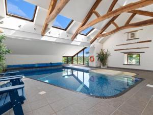 a swimming pool in a building with windows at 4 Bed in Hebron oc-y30097 in Whitland
