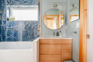 a bathroom with a sink and a mirror at Modern Cabin near Watkins Glen in Alpine +28 photos