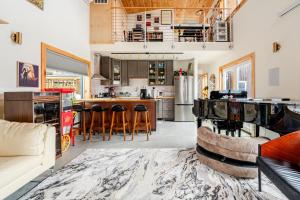 a kitchen and living room with a bar with stools at Modern Cabin near Watkins Glen in Alpine