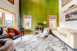 a living room with green walls and a white couch at Modern Cabin near Watkins Glen in Alpine