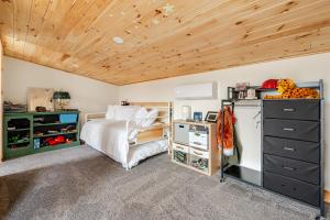 a bedroom with a bed and a wooden ceiling at Modern Cabin near Watkins Glen in Alpine