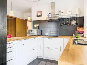 a kitchen with white cabinets and a counter top at Apartment Martin by Interhome in Frankenau