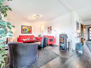 a living room with a red couch and a table at Apartment Martin by Interhome in Frankenau