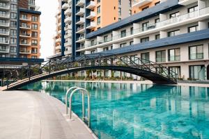 a bridge over a body of water with buildings at Riverside Life Residence in Trikomo