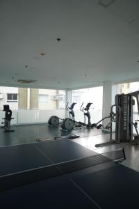 a gym with several people exercising on tread machines at The Storeys - Mesaverte Residences CDO in Pontud