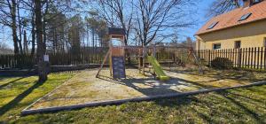 a playground in a yard next to a house at Esterházy Fogadó in Gánt