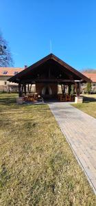a pavilion with picnic tables in a park at Esterházy Fogadó in Gánt
