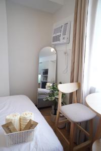 a small room with a bed and a mirror at The Storeys - Mesaverte Residences CDO in Pontud +10 photos