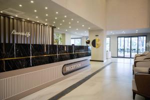 a lobby with a reception desk in a building at Riverside Life Residence in Trikomo +90 photos