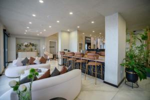 a living room with two white couches and a table at Riverside Life Residence in Trikomo