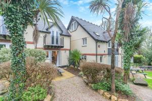 a house with palm trees in front of it at 3 Bed in St. Ives oc-c30315 in Carbis Bay