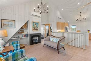 a living room with a couch and a fireplace at Boots to Beach in Duck
