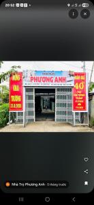 a building with signs on the front of it at Home 100k in Vị Thanh