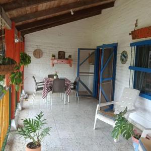 a dining room with a table and chairs at Ingenia Casa Hostal in Palmira
