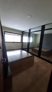 a room with glass walls and a room with a table at Casa dos Vieira in Marataizes