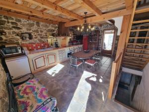 a kitchen with a table and chairs in a room at Maison Le Rêve in Evisa