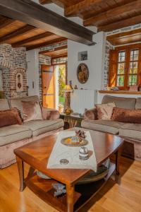 a living room with couches and a coffee table at xenonas ton xromaton - Guest house of colors in Lafkos
