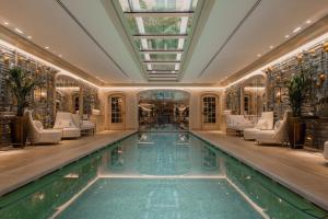 an indoor pool in a house with a glass ceiling at Hotel de Crillon in Paris