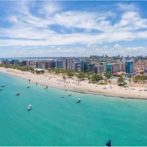 a view of a beach with boats in the water at Pousada Maré Alta in Maceió