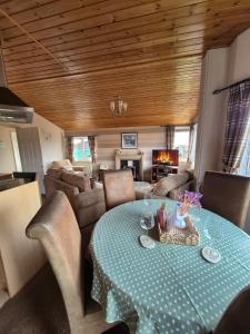 a living room with a table and a couch at Ocean View Lodge - Sea Views & Decking in Ilfracombe
