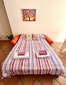 a bed with two pillows on it in a room at La Dolce Vita in Bracciano