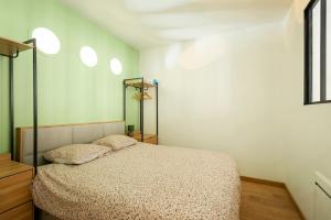 a bedroom with a bed and two pillows on it at COCKTAIL & DREAM #Hyper Centre# Renové# fully equiped in Chalon-sur-Saône