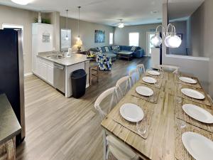 a kitchen and living room with a long wooden table at Hammonds Reef in Padre Island