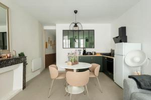 a kitchen with a table and chairs in a room at COCKTAIL & DREAM #Hyper Centre# Renové# fully equiped in Chalon-sur-Saône +20 photos