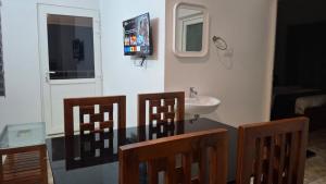 a bathroom with a table and two chairs and a sink at Samudra Retreats Vagamon in Vagamon
