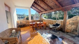 a room with a hammock and a stone wall at Budoni Casa Vacanze - MAR DEI CORALLI in Budoni