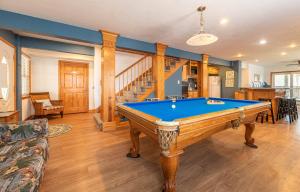 a living room with a pool table in it at Paradise Found - Nags Head MP 16.5, Oceanfront, Ocean & Sound Views, Pool, Hot Tub, Pets OK in Nags Head
