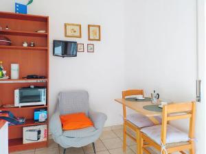 a room with a desk and a chair and a table at Apartment Euroville-2 by Interhome in Germignaga