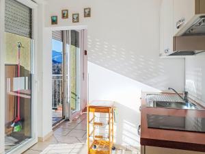 a kitchen with a staircase leading to a balcony at Apartment Euroville-2 by Interhome in Germignaga +27 photos