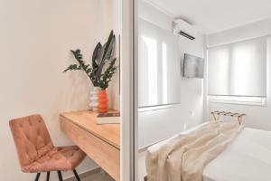 a bedroom with a desk and a chair and a bed at Elan Suites Preveza in Preveza