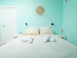 a large white bed with two pillows on it at AlsAppart, duplex climatisé à 5 min de Colmar in Sainte-Croix-en-Plaine